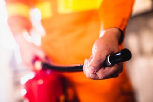 hand holding fire extinguisher